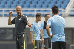 City head coach Pep Guardiola (L) during training.