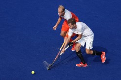 Benjamin Martin #2 of Canada moves the ball past Billy Bakker #8 of Netherlands during the hockey game on Day 4 of the Rio 2016 Olympic Games at the Olympic Hockey Centre on August 9, 2016 in Rio de Janeiro, Brazil. 