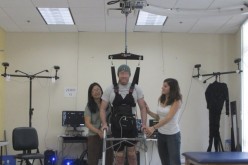 A paraplegic man is able to walk again after undergroing a brain-robot program that helps cure paralysis.