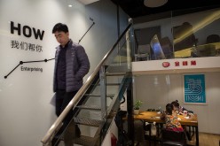 A man walks down the stairs of the JD + milk tea shop.