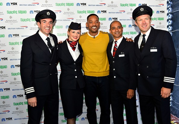 British Airways pilots Andy Perkins(R) and Will Swinburn(L) pose for a group photo with Will Smith during an exclusive Q&A about his role in his latest blockbuster Suicide Squad, on August 7, 2016 in Dubai, United Arab Emirates.