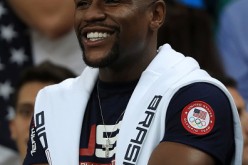 Floyd Mayweather is smiling courtside while watching the USA Olympic basketball squad in a game against Argentina in Rio de Janeiro, Brazil.