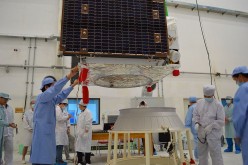 Technical staff put on a rocket adaptor to the quantum communication satellite at the Jiuquan Satellite Launch Center in Jiuquan, Gansu Province.