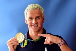 Competitive swimmer Ryan Lochte of the United States poses for a photo with his gold medal on the Today show set on Copacabana Beach on August 12, 2016 in Rio de Janeiro, Brazil. 