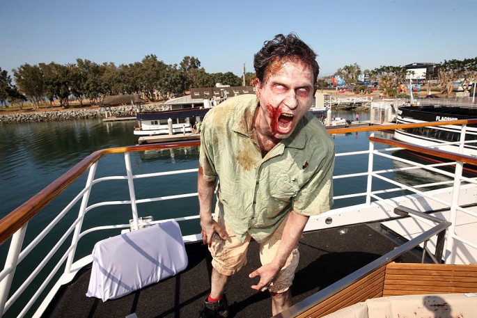 Actors playing zombies walk at the 'Fear the Walking Dead' activation during San Diego Comic-Con International 2016 at the Abigail boat on July 21, 2016 in San Diego, California.