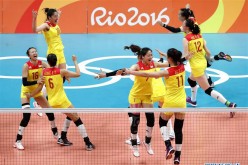 China's players celebrate after the women's gold medal match of Volleyball against Serbia at the 2016 Rio Olympic Games in Rio de Janeiro, Brazil, on Aug. 20, 2016. China won the gold medal.