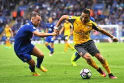 Arsenal forward Alexis Sanchez (R) drives past Leicester City's Danny Drinkwater.