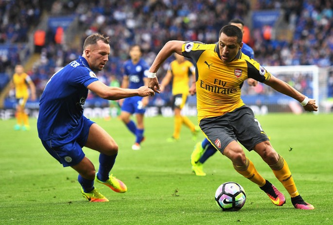 Arsenal forward Alexis Sanchez (R) drives past Leicester City's Danny Drinkwater.