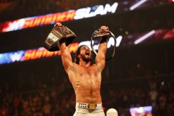 Seth Rollins celebrating at SummerSlam 2015 after defeating John Cena in a winner take all match for the WWE World Heavyweight and United States championships.