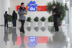 People walk past the reception area of Baidu's headquarters in Beijing.