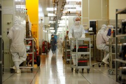 Workers operate in the wafer division of Semiconductor Manufacturing International Corp in Shanghai, one of the largest chip foundries in the world.
