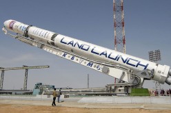 Visitors look at a rocket carrying an Israeli Amos-3 telecommunications satellite on a launch pad at Kazakhstan's Baikonur cosmodrome. 