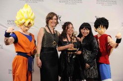 Samantha Artal Susskand and Paula Andrea Gomez Vera pose with actors dressed as cartoon characters Goku and Luffy at Nespresso Press Room at the 39th International Emmy Awards.  