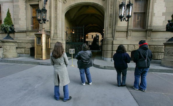 Fans stand in front of the Dakota apartments where John Lennon was murdered December 7, 2005 next to Central Park in New York City. Lennon was killed by Mark David Chapman in front of the Dakota apartments December 8, 1980.   