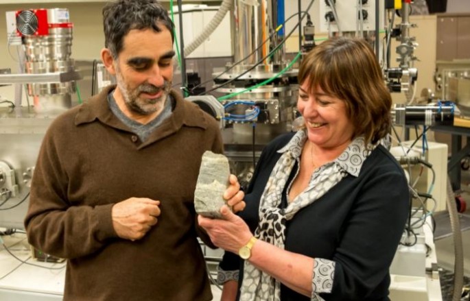 Researchers Allen Nutman and Vickie Bennett show a 3.7-billion-year-old fossilized stromatolite from Isua, Greenland. 