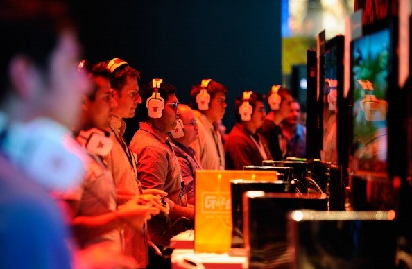 Gamers and show attendees play video games at the XBOX 360 booth during the Electronic Entertainment Expo on June 7, 2011 in Los Angeles, California.