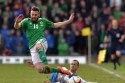 Stuart Dallas (L) of Northern Ireland is tackled by Sakari Mattila (R) of Finland during the EURO 2016 Group F qualifier at Windsor Park on March 29, 2015 in Belfast, Northern Ireland. (Photo by Charles McQuillan/Getty Images)