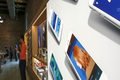 A poster that contains pictures of iPhones is displayed the new Brooklyn Apple Store during a media preview in the Williamsburg neighborhood of Brooklyn on July 28, 2016 in New York City. The Williamsburg Apple Store opens next Saturday on July 30th, it i