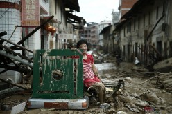 A woman sits amid the destruction left behind by Typhoon Nepartak in China.