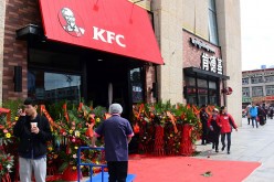 People walk in front of a KFC fast food restaurant in Lhasa, Tibet Autonomous Region.