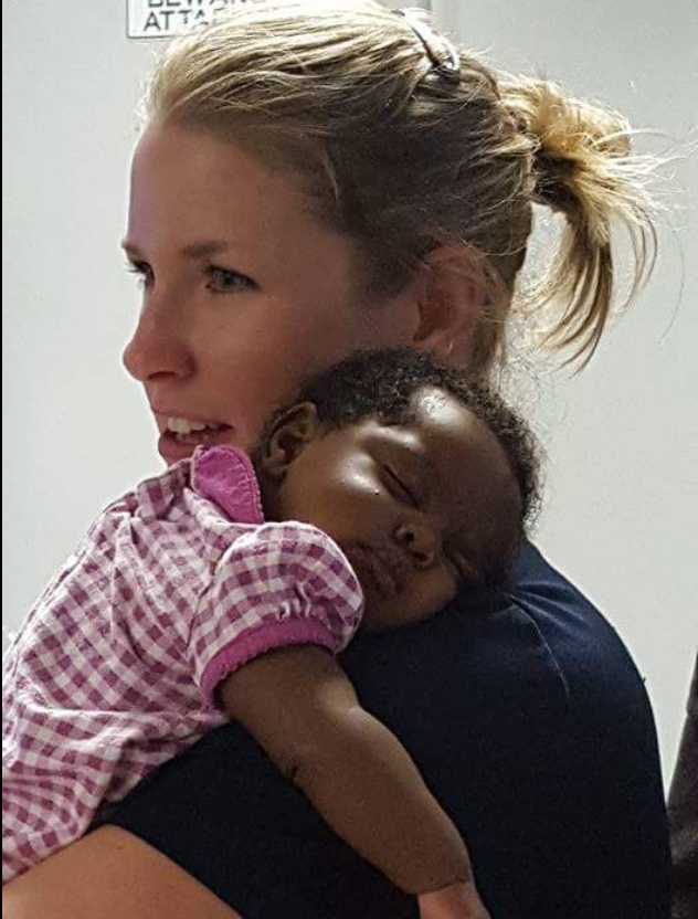 Michelle Burton, a Birmingham police officer comforts a baby on Aug 30, 2016 