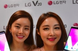 South Korean models pose with LG's new premium smartphone V20 during a launch event in Seoul on September 7, 2016.