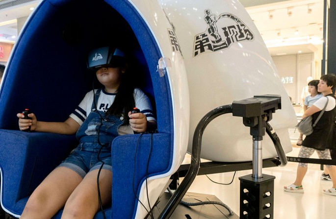 A child plays a game using a VR device in a mall in China, the next battleground for VR markets.