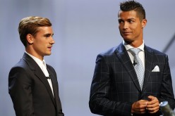 Real Madrid's Portuguese forward Cristiano Ronaldo (R) looks at Atletico Madrid's French forward Antoine Griezmann at the end of the UEFA Champions League Group stage draw ceremony.