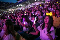 South Korean K-Pop fans cheer as a K-Pop band perform on stage on June 18, 2016 in Suwon, South Korea. 