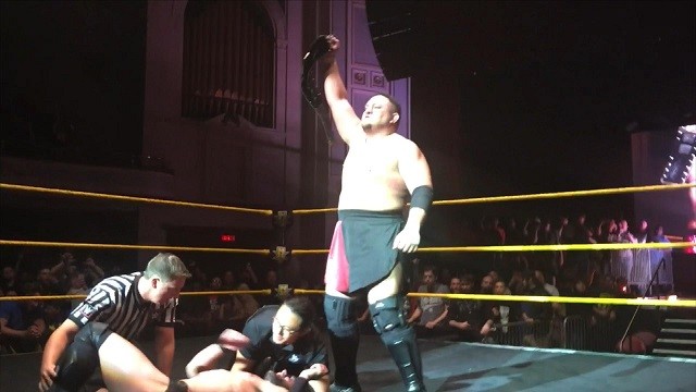 Samoa Joe celebrates winning the NXT championship against Finn Balor in an NXT Live Event.