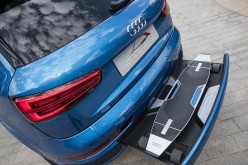 Audi shows a prototype of its connected mobility vehicle, with an electrically powered longboard and scooter hybrid, outside the company's headquarters in Beijing.