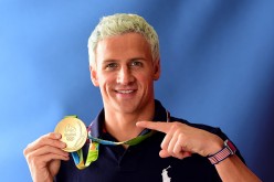 Ryan Lochte shows off his Olympic Gold for team USA in swimming.
