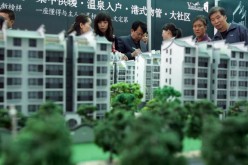 Visitors view architects' models of apartment blocks during the 2007 Xian Autumn Real Estate Trade Fair on Oct. 26, 2007 in Xian of Shaanxi Province, China.