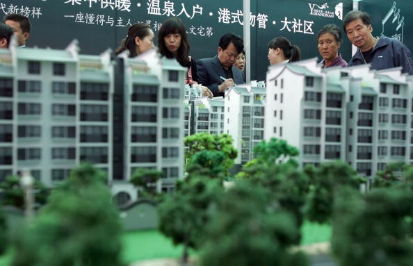 Visitors view architects' models of apartment blocks during the 2007 Xian Autumn Real Estate Trade Fair on Oct. 26, 2007 in Xian of Shaanxi Province, China.