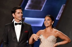 John Stamos and Gina Rodriguez speak onstage during the 67th Annual Primetime Emmy Awards at Microsoft Theater on September 20, 2015 in Los Angeles, California.
