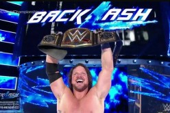 A.J. Styles celebrates after winning the WWE World Championship at Backlash.