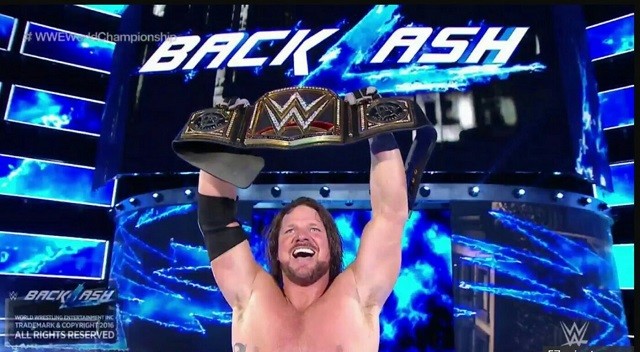 A.J. Styles celebrates after winning the WWE World Championship at Backlash.