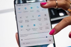 A Samsung smartphone is held by hand in order to clearly showcase its features. 
