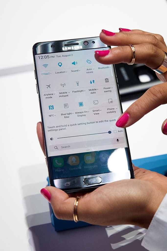 A Samsung smartphone is held by hand in order to clearly showcase its features. 