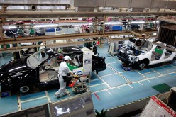 A worker checks a car in the GAC assembly plant in Guangzhou, Guandong Province.