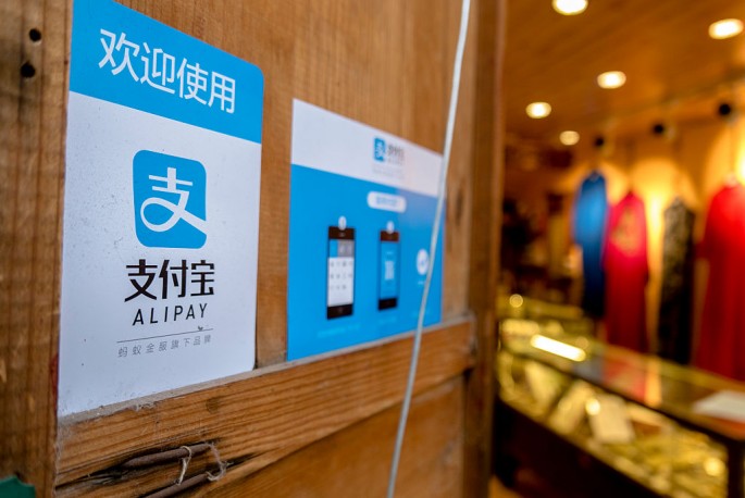 A clothes shop in Lijiang, Yunnan Province, displays a signboard telling customers that it accepts payments through Alipay.