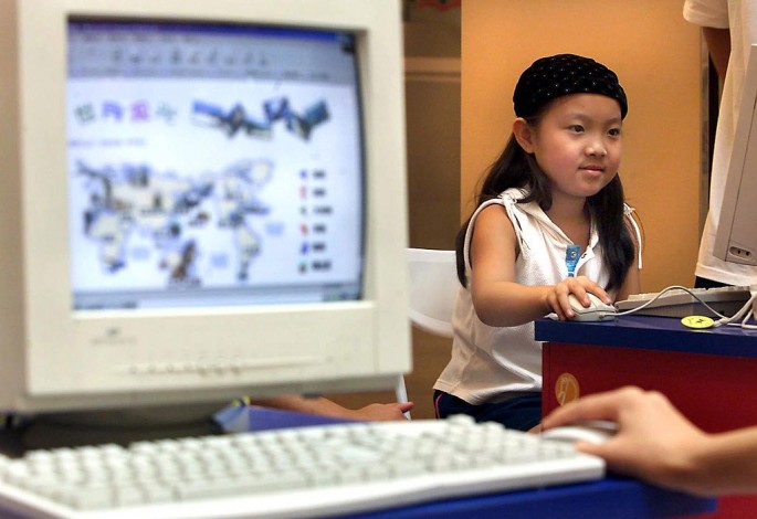 A young girl surfs the Web in China, where minors are prohibited to enter Internet cafes.