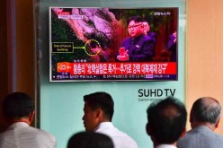 People watch a television news report, showing file footage of North Korean leader Kim Jong-Un, at a railway station in Seoul on September 9, 2016.