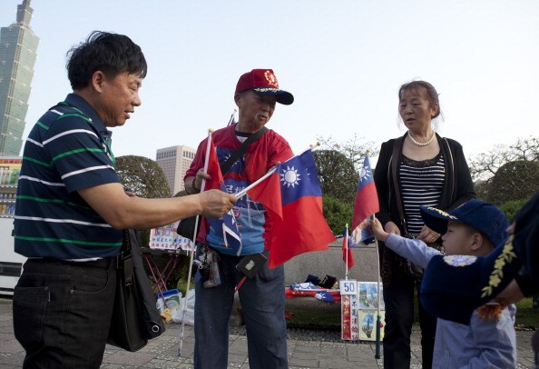 Chinese tourists buy Taiwan flags from a vendor in Dr. Sun Yat-sen Memorial Hall on April 15, 2013, in Taipei, Taiwan.