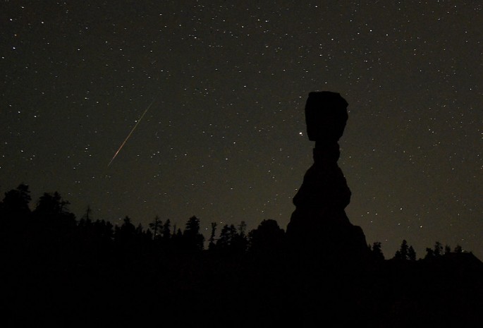 A Perseid meteor streaks across the sky left of the hoodoo named Thor's Hammer early on August 13, 2016 in Bryce Canyon National Park, Utah. The annual display, known as the Perseid shower because the meteors appear to radiate from the constellation Perse
