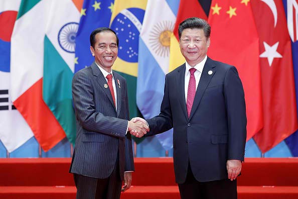 Indonesian President Joko Widodo shakes hands with Chinese President Xi Jinping during a visit.