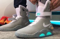 A guy tries on the new self-lacing Nike Mags shoes.