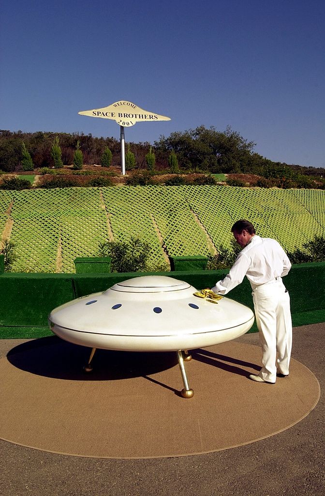 William Protor polishes a model flying saucer on property near Jamul, CA, October 15, 2000, purchased by the Unarius Academy of Science to serve as a future landing site for 'space brothers' from other planets.