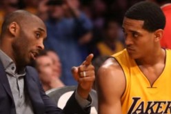 Kobe Bryant talks to Jordan Clarkson while on the bench of the Lakers.
