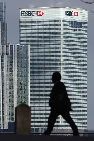 A man is silhouetted against the HSBC Holdings Plc headquarter in the Canary Wharf business, financial and shopping district on Feb. 15, 2016, in London, England.